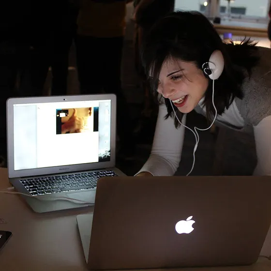Sara Salsinha laughing whilst talking to two computers